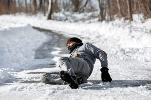 Man Fallen on snowy, icy road